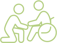 Two simple green line figures, one kneeling and assisting another figure in a wheelchair.